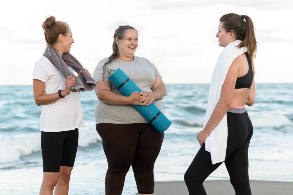 A group of women jogging along the shoreline of a beach, wearing athletic clothing and enjoying the outdoor scenery with water in the background. Exercise Is Keeping People Fat But No One Wants to Talk About It